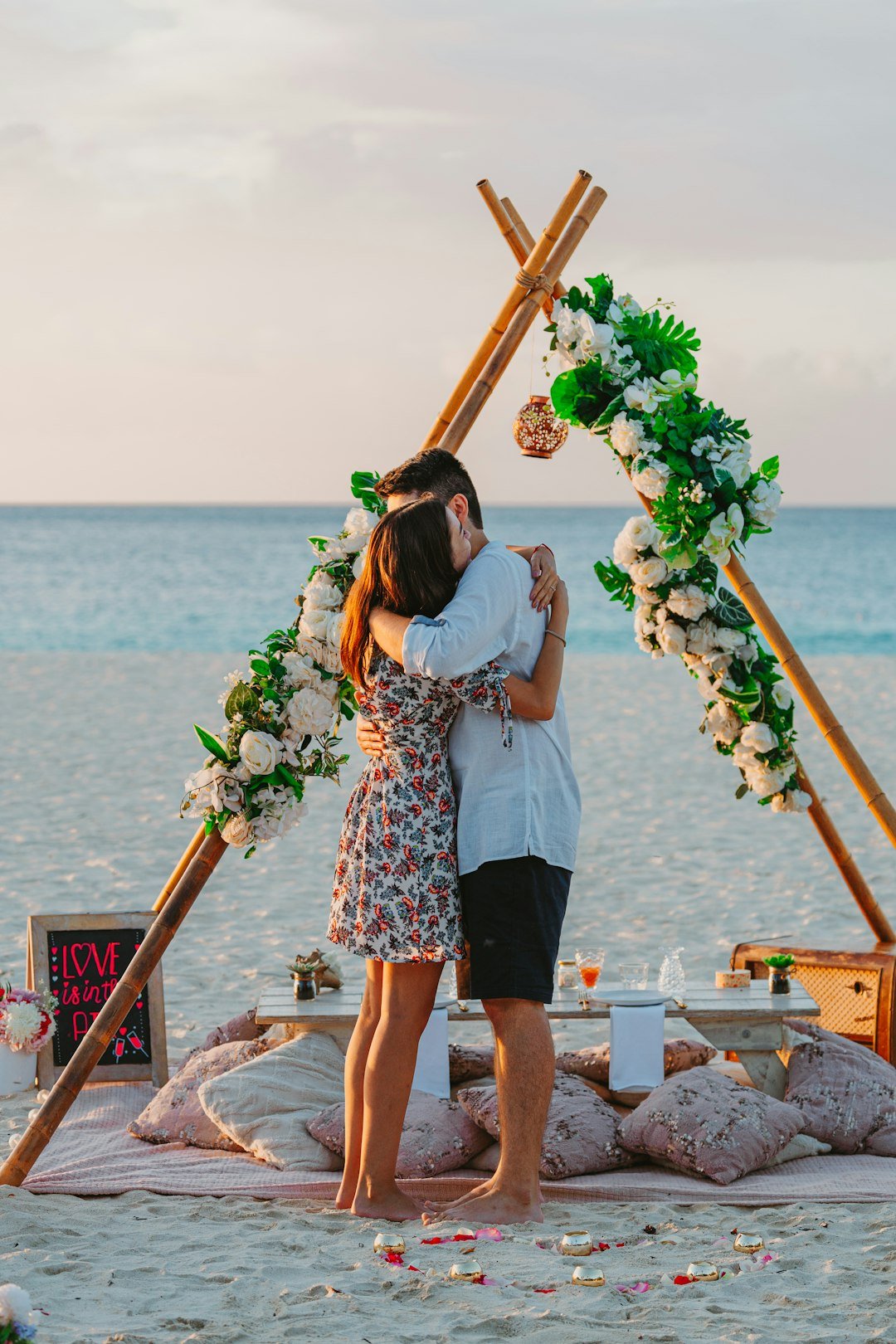a-couple-embraces-after-a-romantic-beach-proposal-ogza-aaphje