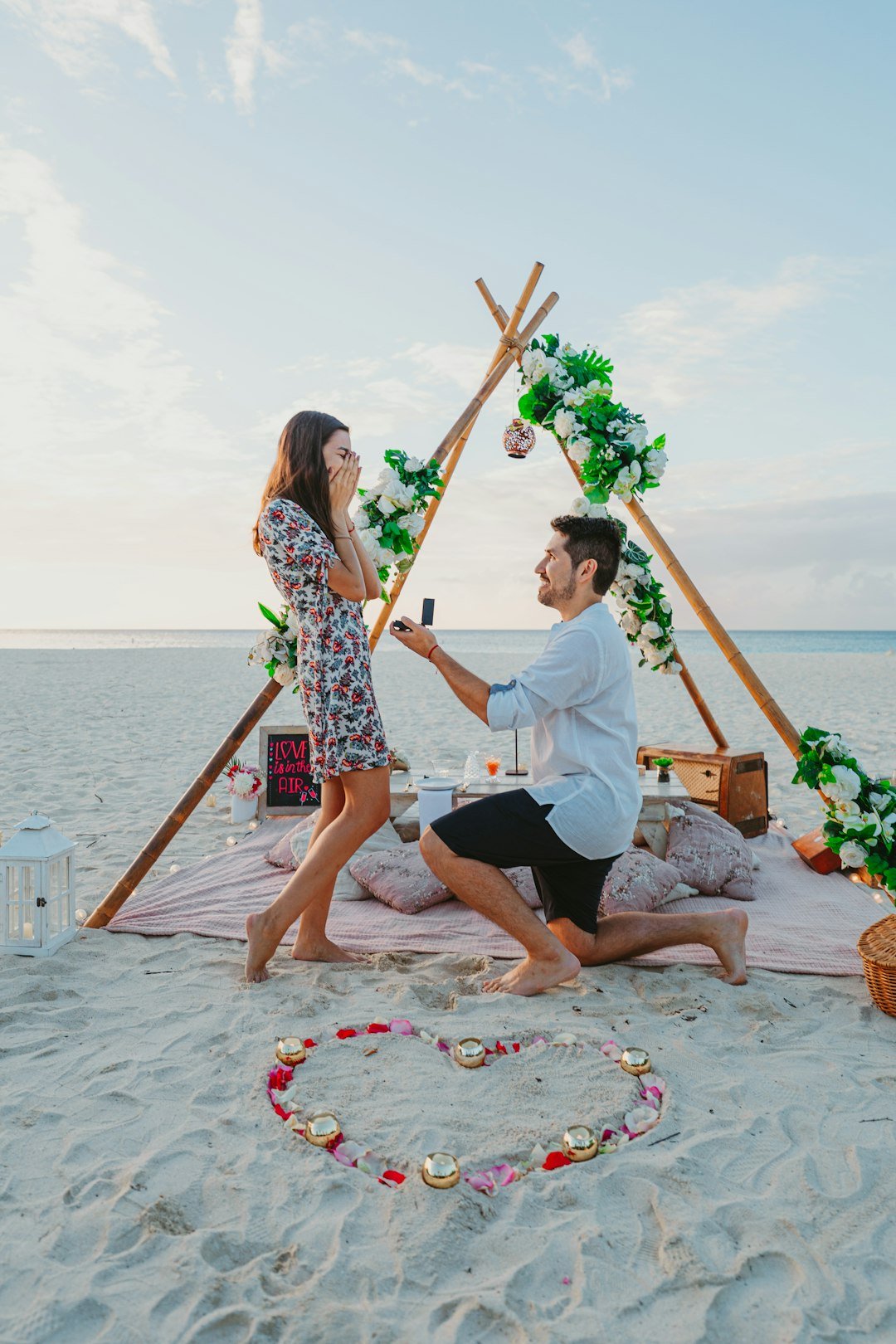 man-proposes-to-woman-on-the-beach-at-sunset-ux8fquscqzu